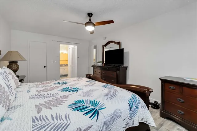 a bedroom with a bed and a television