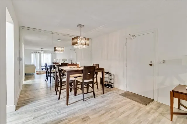 a view of a a dining room with furniture window and wooden floor