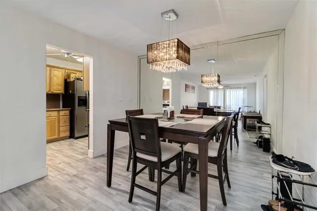 a view of a dining room with furniture and a chandelier