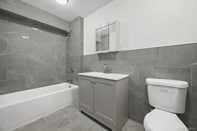 a bathroom with a toilet a sink and bathtub