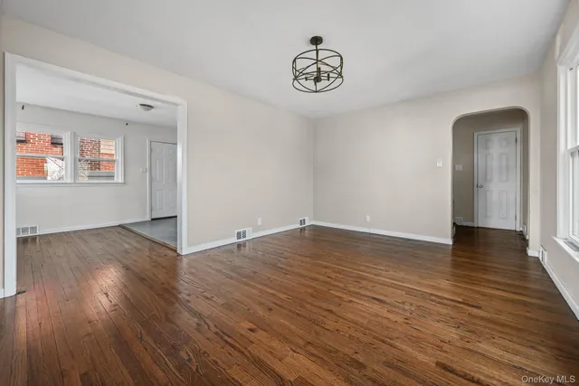a view of a room with wooden floor and window