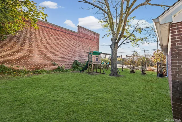 a view of a trees in front of a brick house