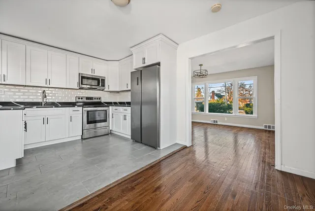 a kitchen with stainless steel appliances a stove a sink and a refrigerator
