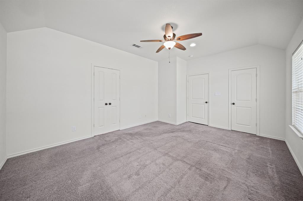 229 Firefly Drive Springtown, TX 76082 - Photo 20 of 33 Spacious room featuring vaulted ceilings, a ceiling fan with integrated lighting, recessed lighting, gray carpeting, and multiple white paneled doors