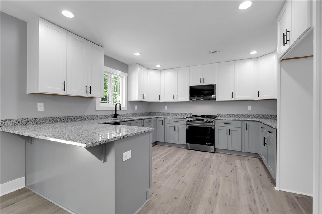 1747 A State Rd S-4-97 Anderson, SC 29621 - Photo 15 of 47 A well-appointed kitchen features ample counter space, contemporary cabinetry, and modern appliances.