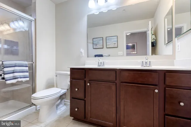 a bathroom with a sink toilet and mirror