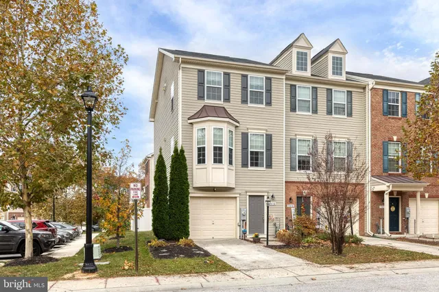 a front view of a residential apartment building with a yard