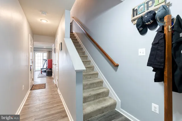 a view of a hallway with wooden floor and entryway