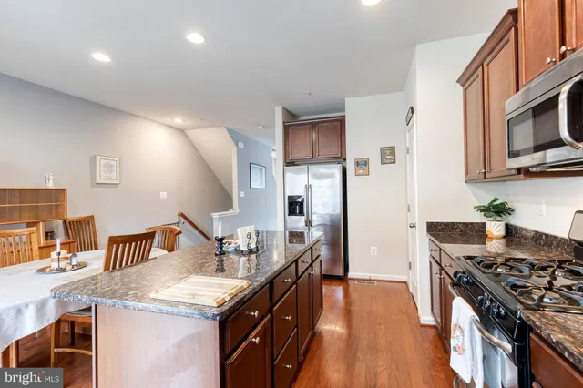 a kitchen with a stove sink and a refrigerator