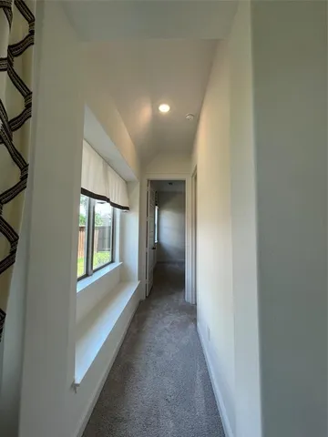 a view of hallway with a window