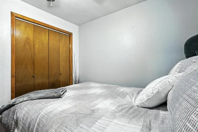 a bedroom with a bed and a window