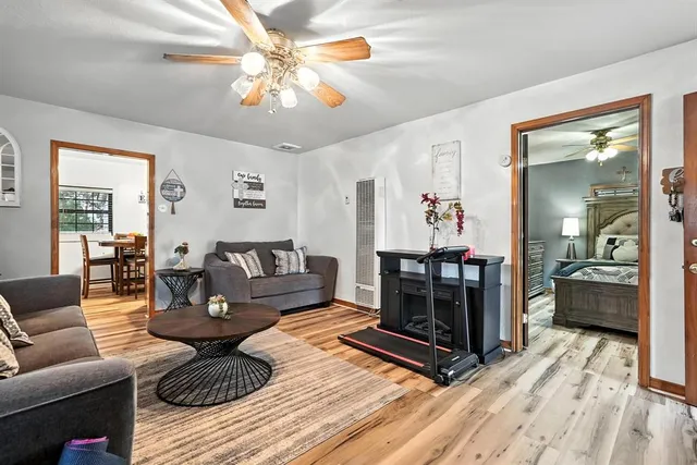 a living room with furniture and a chandelier