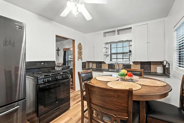a kitchen with a stove a sink and a refrigerator