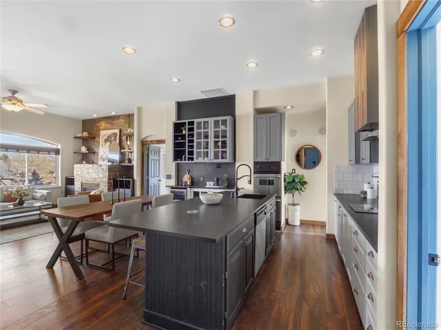 a kitchen with stainless steel appliances a sink a stove top oven a counter space and cabinets