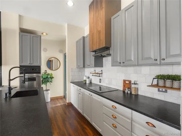 a kitchen with a sink a counter and cabinets