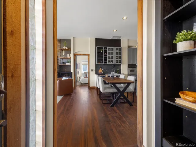 a living room with furniture fireplace and a large window