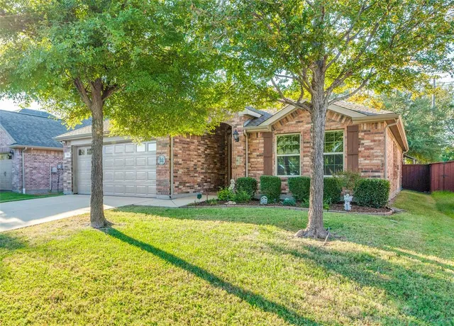 a view of a house with a yard and tree s