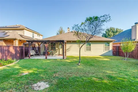 a view of a house with a yard and sitting area