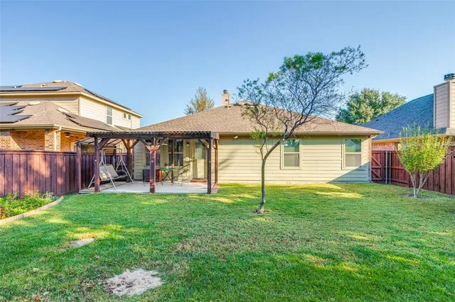 a view of a house with a yard and sitting area