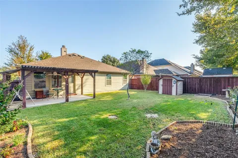a view of a house with a yard and sitting area