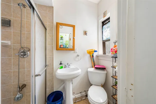 a bathroom with a toilet sink and shower