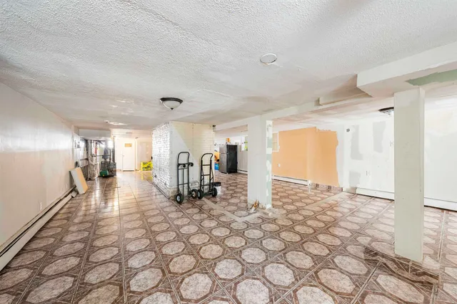 a view of a hallway with wooden floor and glass door