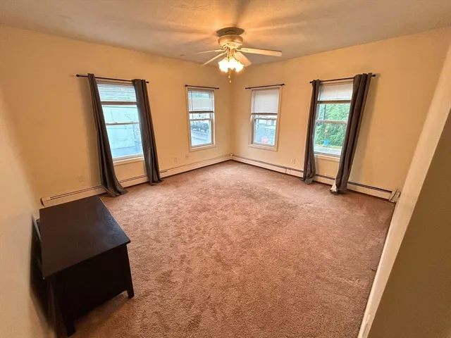 an empty room with windows and closet