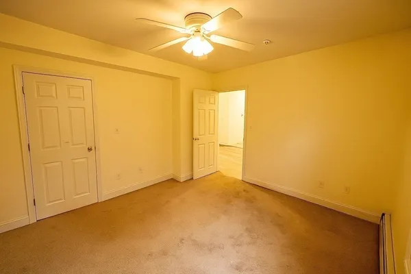 a view of empty room with ceiling fan
