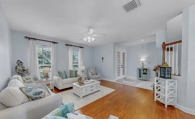 a view of a dining room with furniture wooden floor and a chandelier