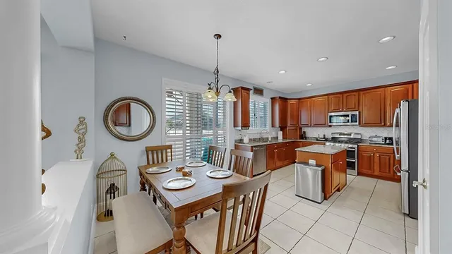 a kitchen with stainless steel appliances granite countertop a refrigerator and a stove top oven