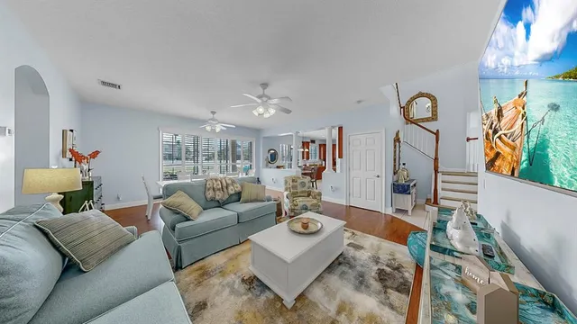 a living room with furniture and a chandelier