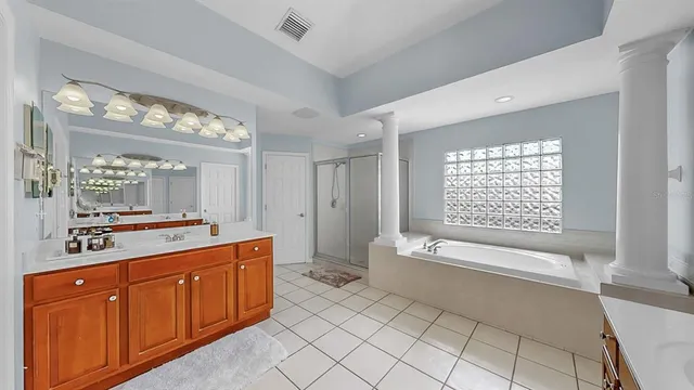 a spacious bathroom with a granite countertop sink and a mirror