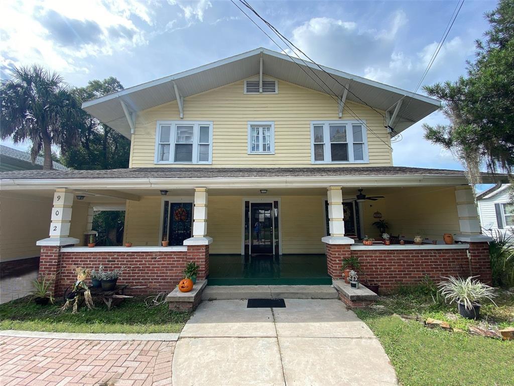 902 South Grove Street, Unit 2 Eustis, FL 32726 - Photo 1 of 11 a front view of a house with a yard and potted plants
