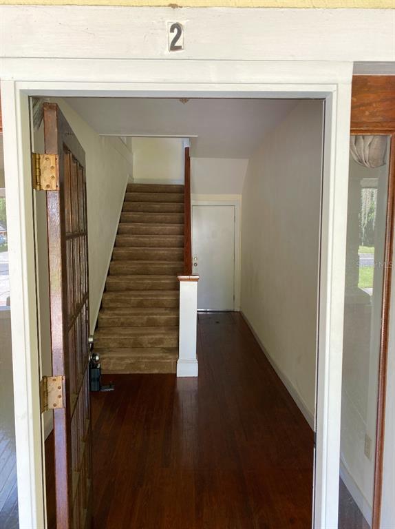 902 South Grove Street, Unit 2 Eustis, FL 32726 - Photo 2 of 11 a view of entryway and hall with wooden floor