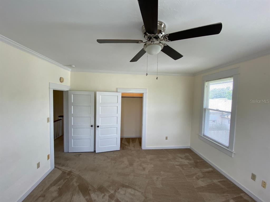902 South Grove Street, Unit 2 Eustis, FL 32726 - Photo 6 of 11 an empty room with closet and windows
