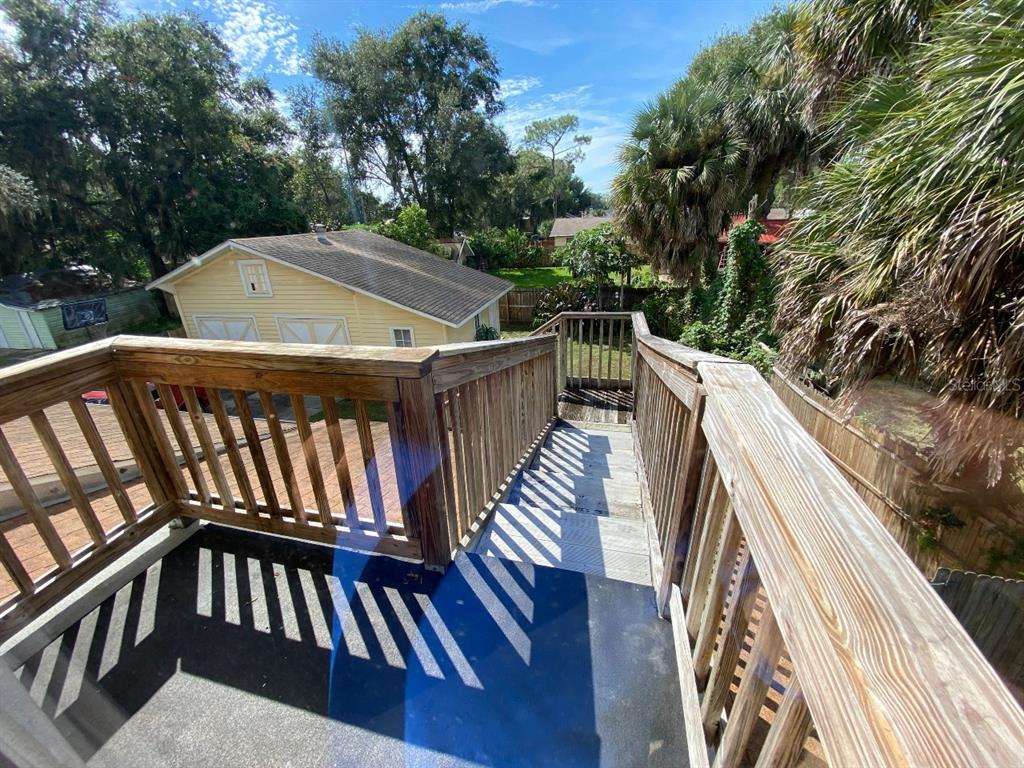 902 South Grove Street, Unit 2 Eustis, FL 32726 - Photo 10 of 11 a view of a roof deck with wooden floor and fence