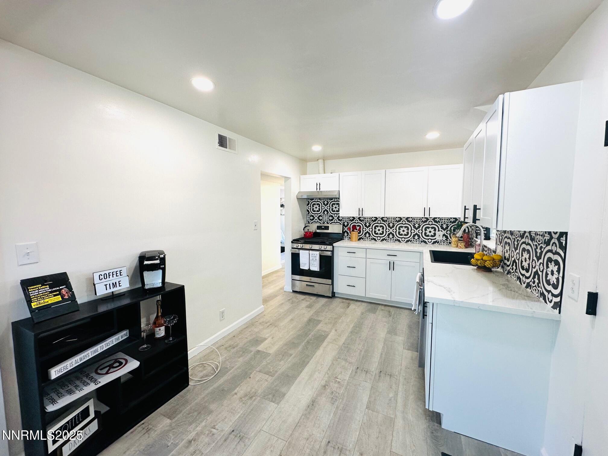 1570 Radcliffe Drive Reno, NV 89502 - Photo 1 of 11 a kitchen with stainless steel appliances a refrigerator and a stove top oven