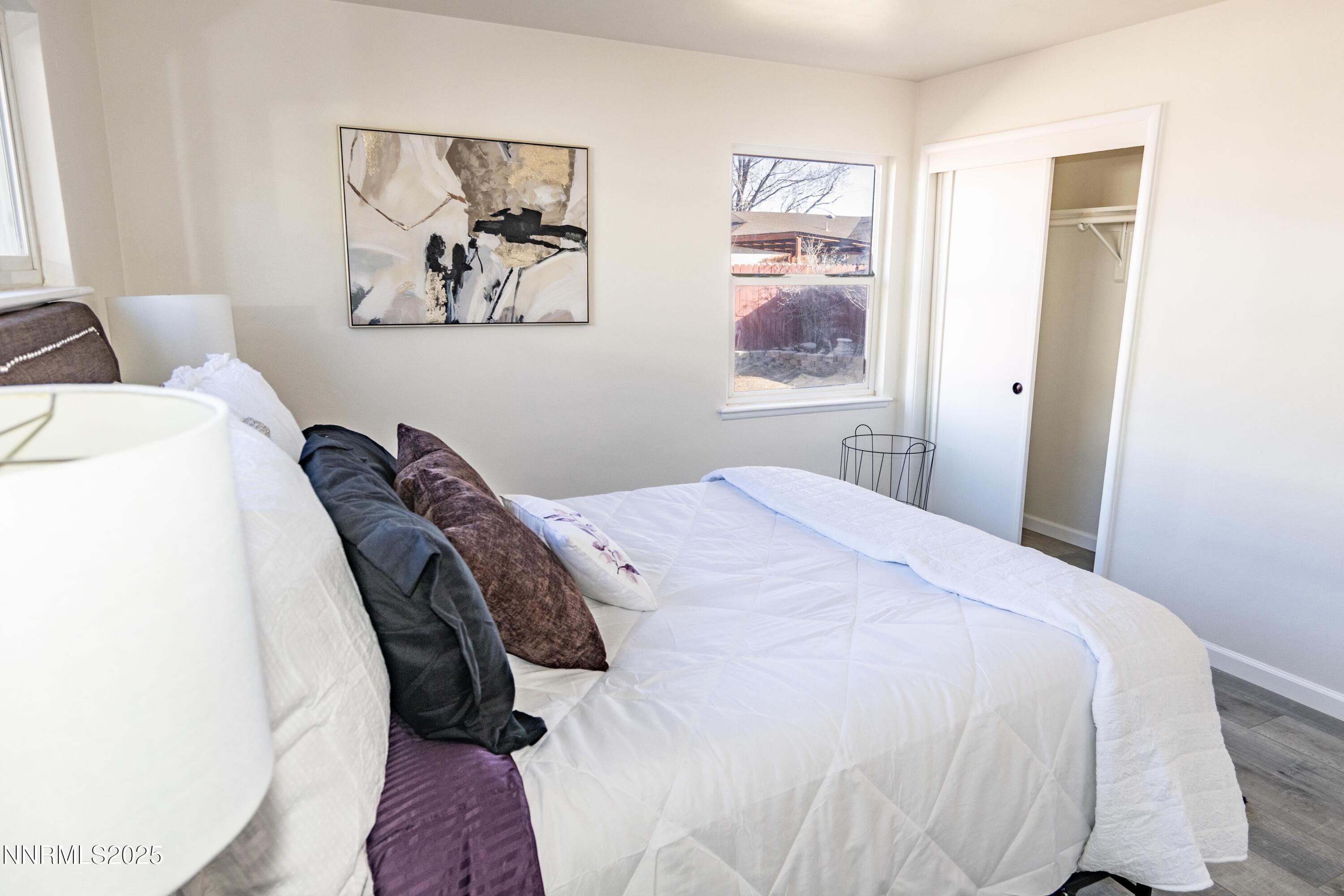 1570 Radcliffe Drive Reno, NV 89502 - Photo 6 of 11 a bedroom with bed and wall painting with wooden floor