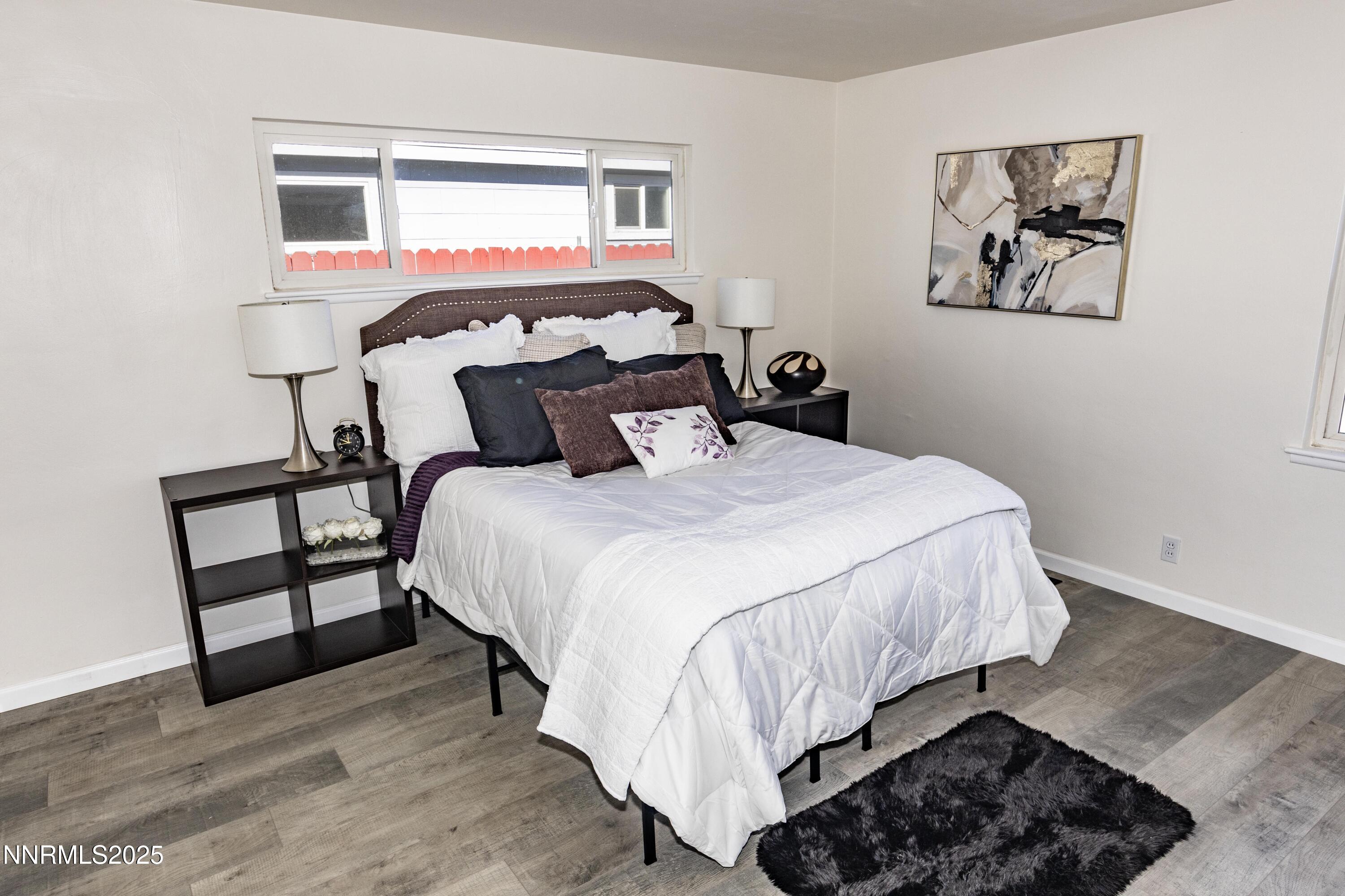 1570 Radcliffe Drive Reno, NV 89502 - Photo 9 of 11 a bedroom with a bed and wooden floor