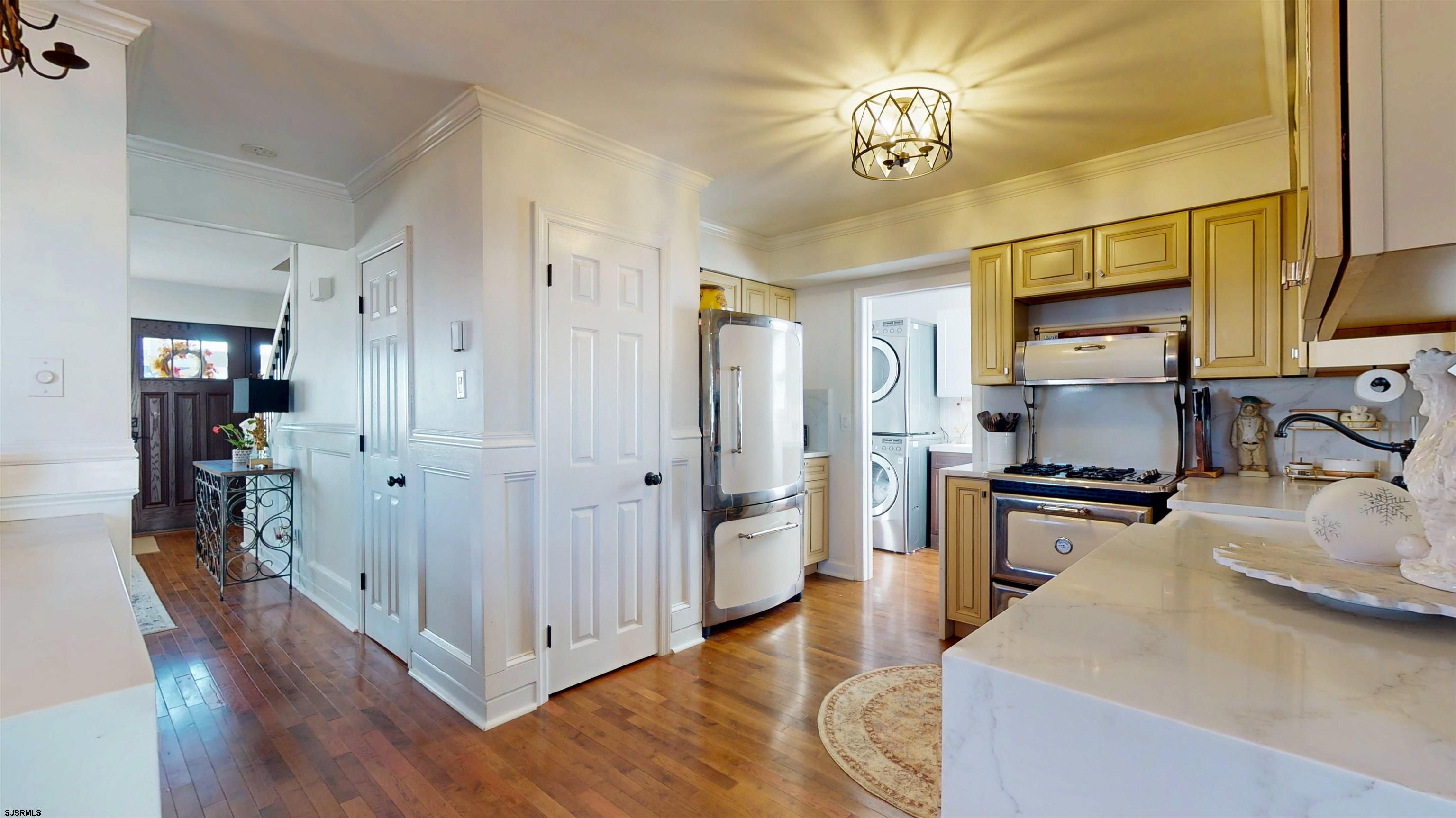 5201 Waterview Drive Brigantine, NJ 08203 - Photo 13 of 33 a kitchen with stainless steel appliances granite countertop a refrigerator a stove and a sink with wooden floor