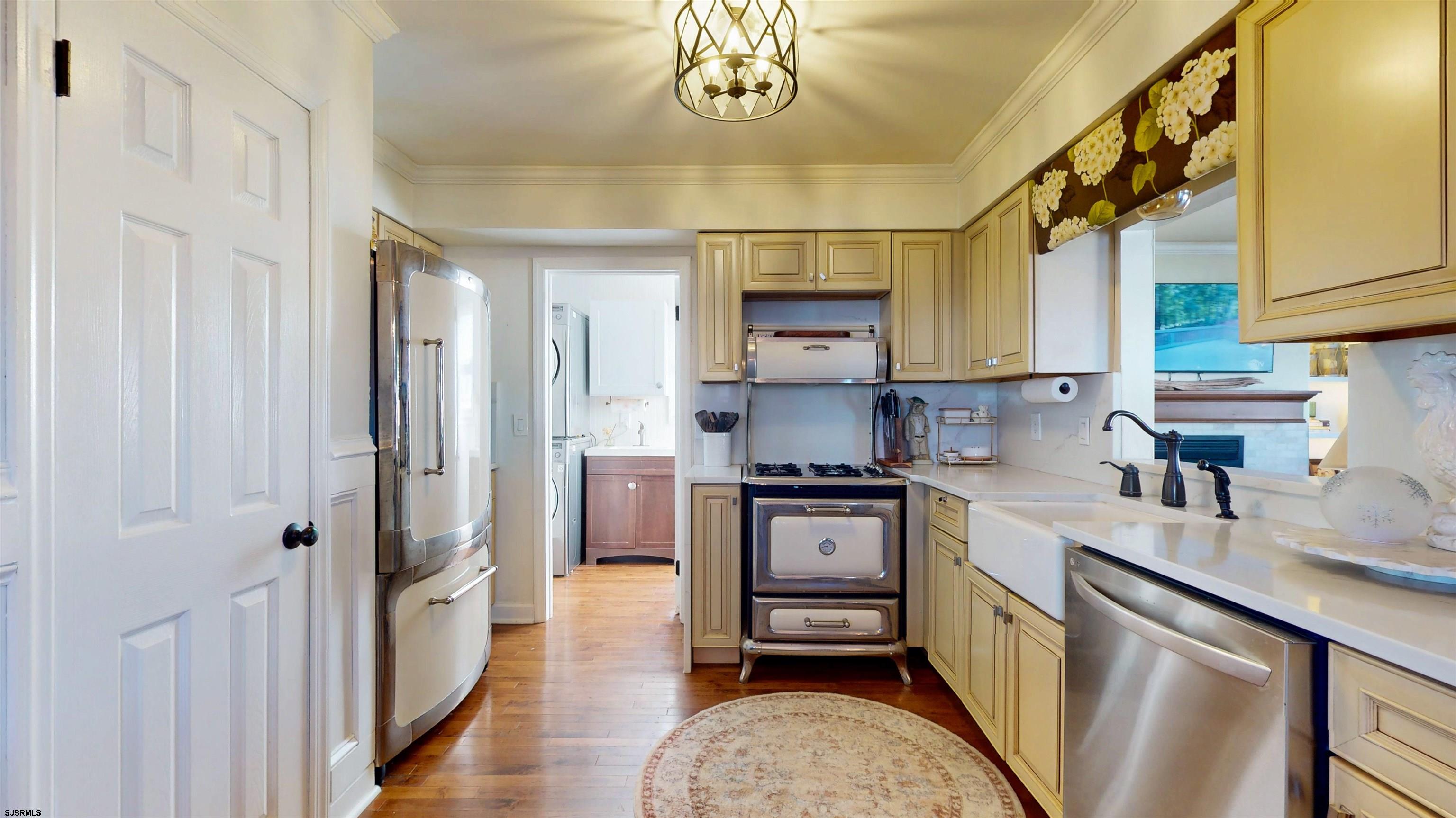 5201 Waterview Drive Brigantine, NJ 08203 - Photo 14 of 33 a kitchen with stainless steel appliances granite countertop a sink a stove a refrigerator cabinets and a dining table