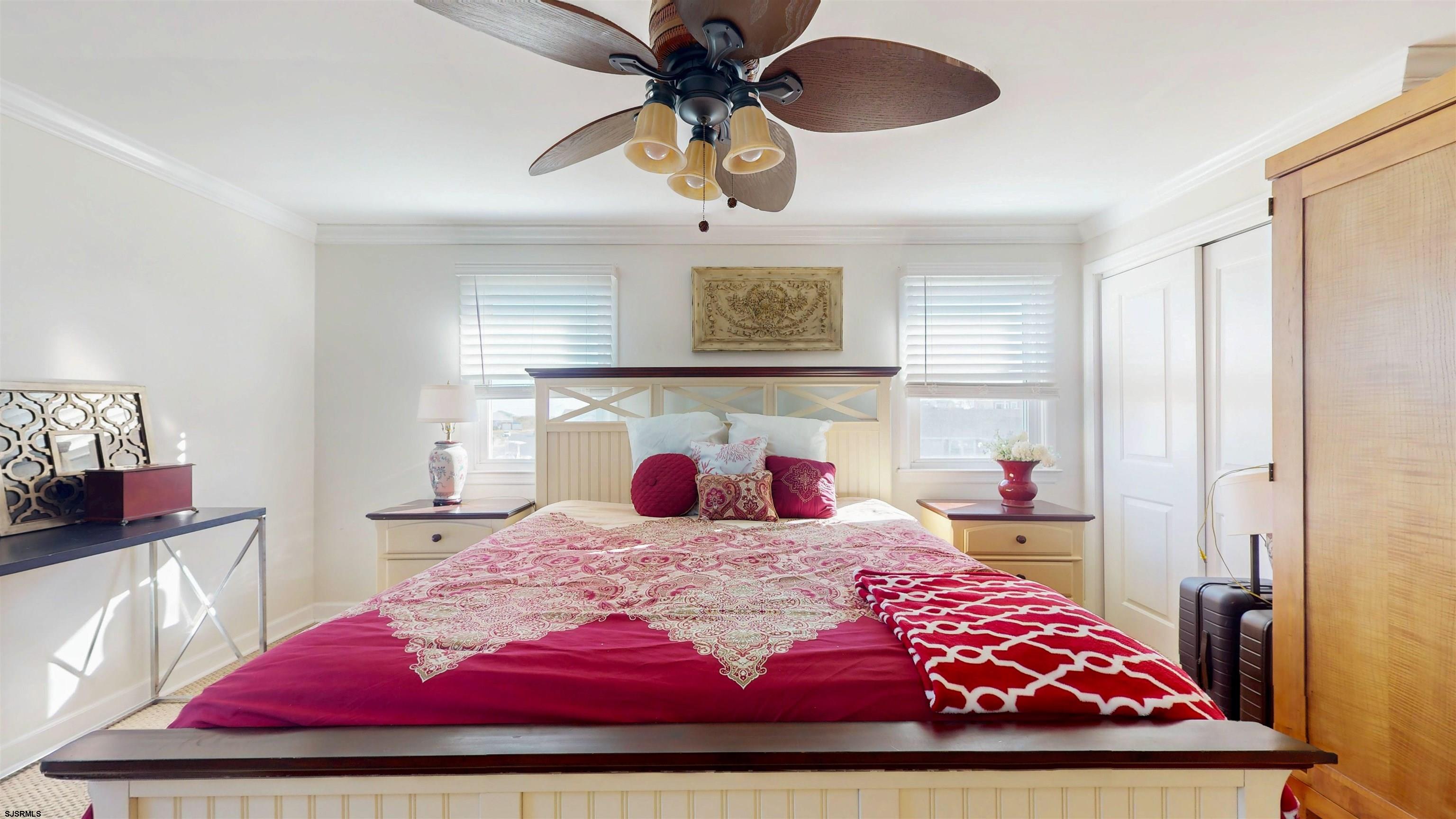 5201 Waterview Drive Brigantine, NJ 08203 - Photo 23 of 33 a bedroom with a large bed and a chandelier