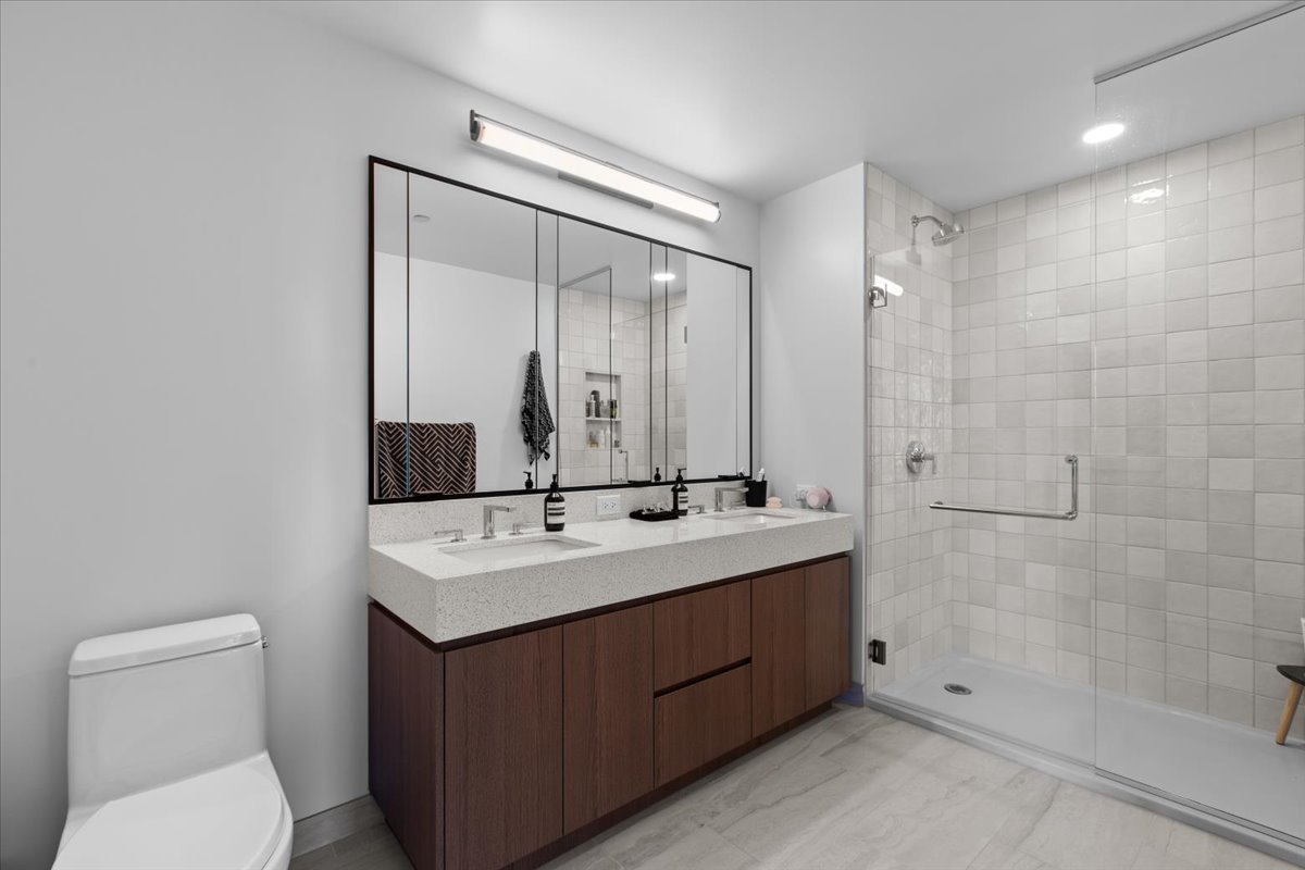 Undisclosed Address Chicago, IL 60607 - Photo 8 of 18 a bathroom with a sink a toilet and shower