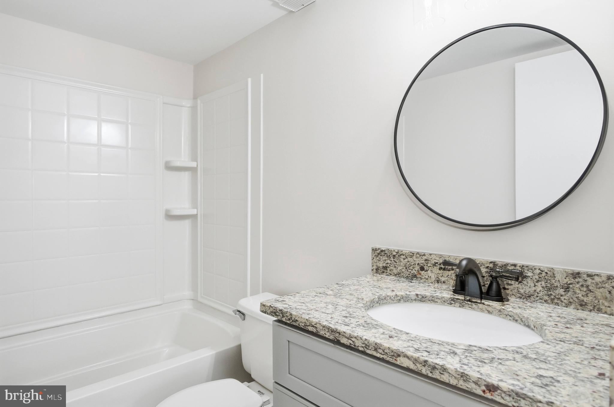 5902 Cove Landing Road, Unit 202 Burke, VA 22015 - Photo 13 of 52 a bathroom with a granite countertop sink mirror and a mirror