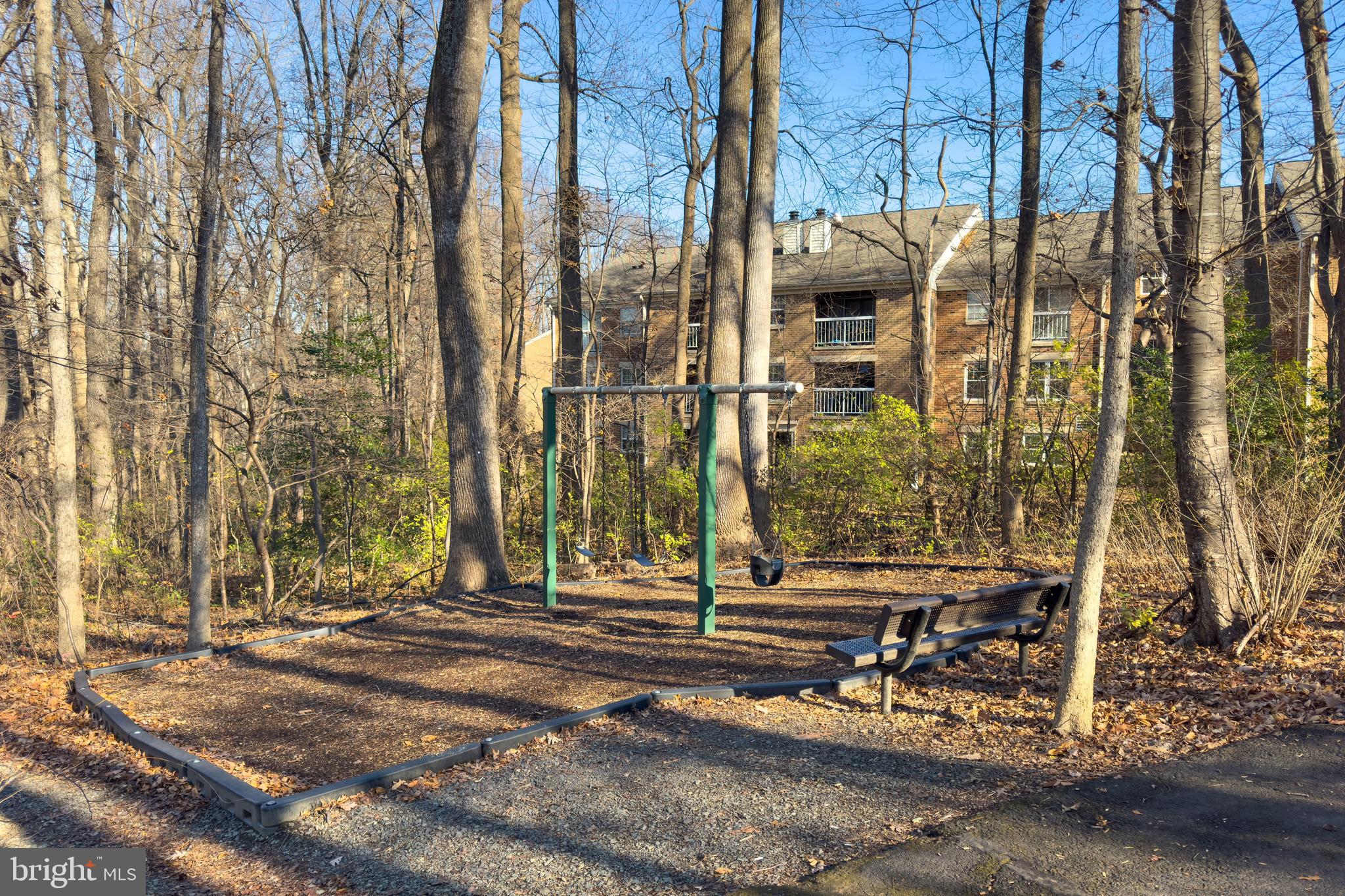 5902 Cove Landing Road, Unit 202 Burke, VA 22015 - Photo 26 of 52 a view of a brick building next to a yard