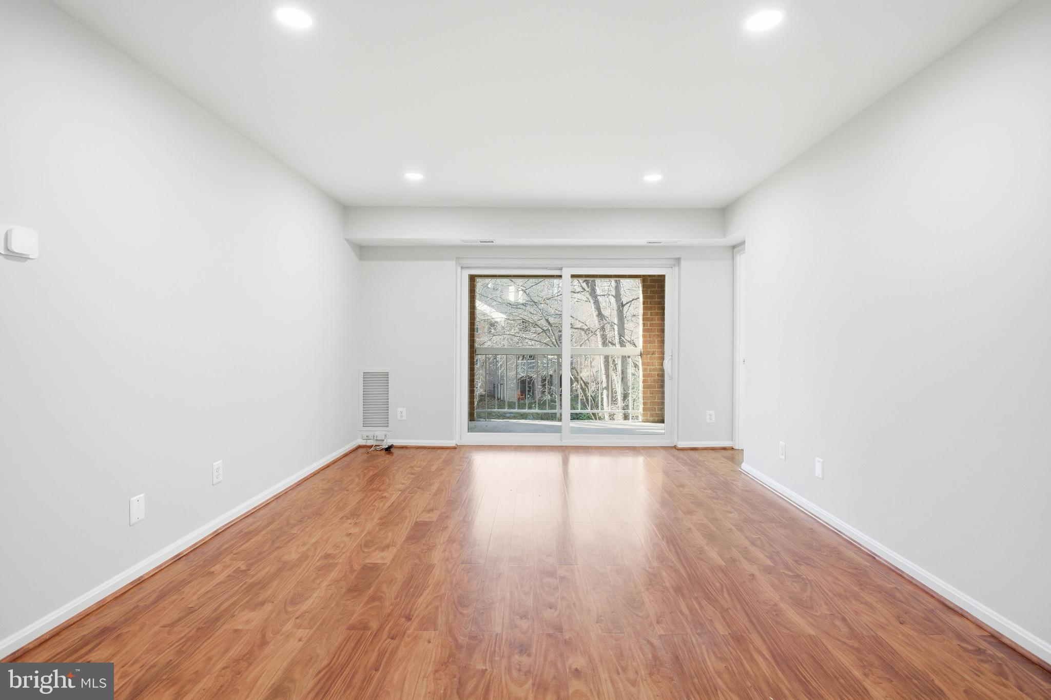5902 Cove Landing Road, Unit 202 Burke, VA 22015 - Photo 3 of 52 wooden floor in an empty room with a window