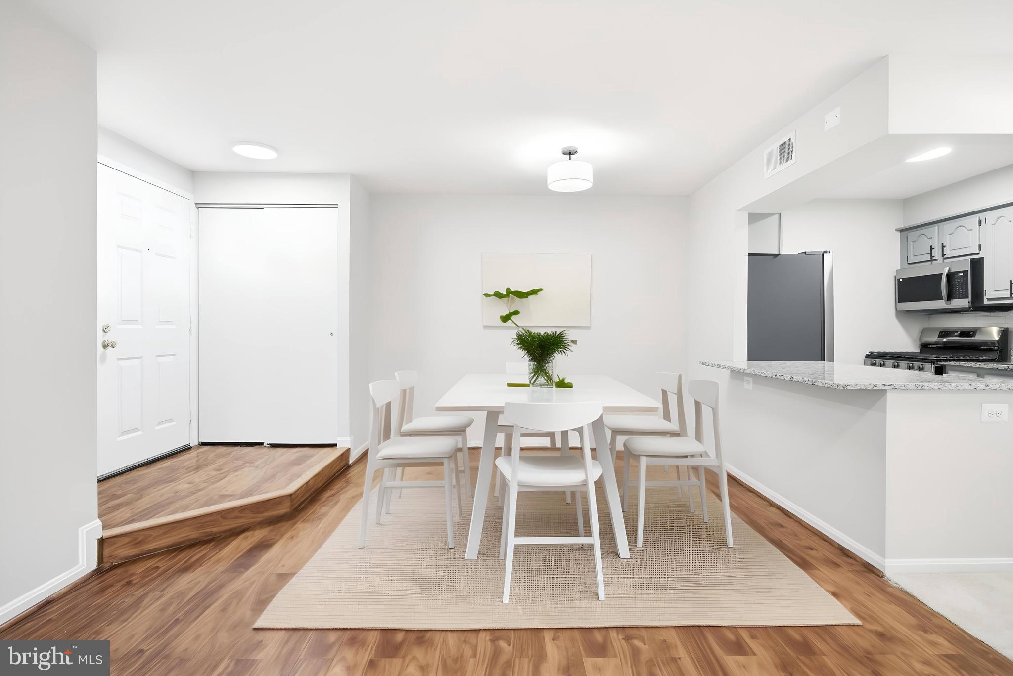 5902 Cove Landing Road, Unit 202 Burke, VA 22015 - Photo 4 of 52 a dining room with furniture and a kitchen view