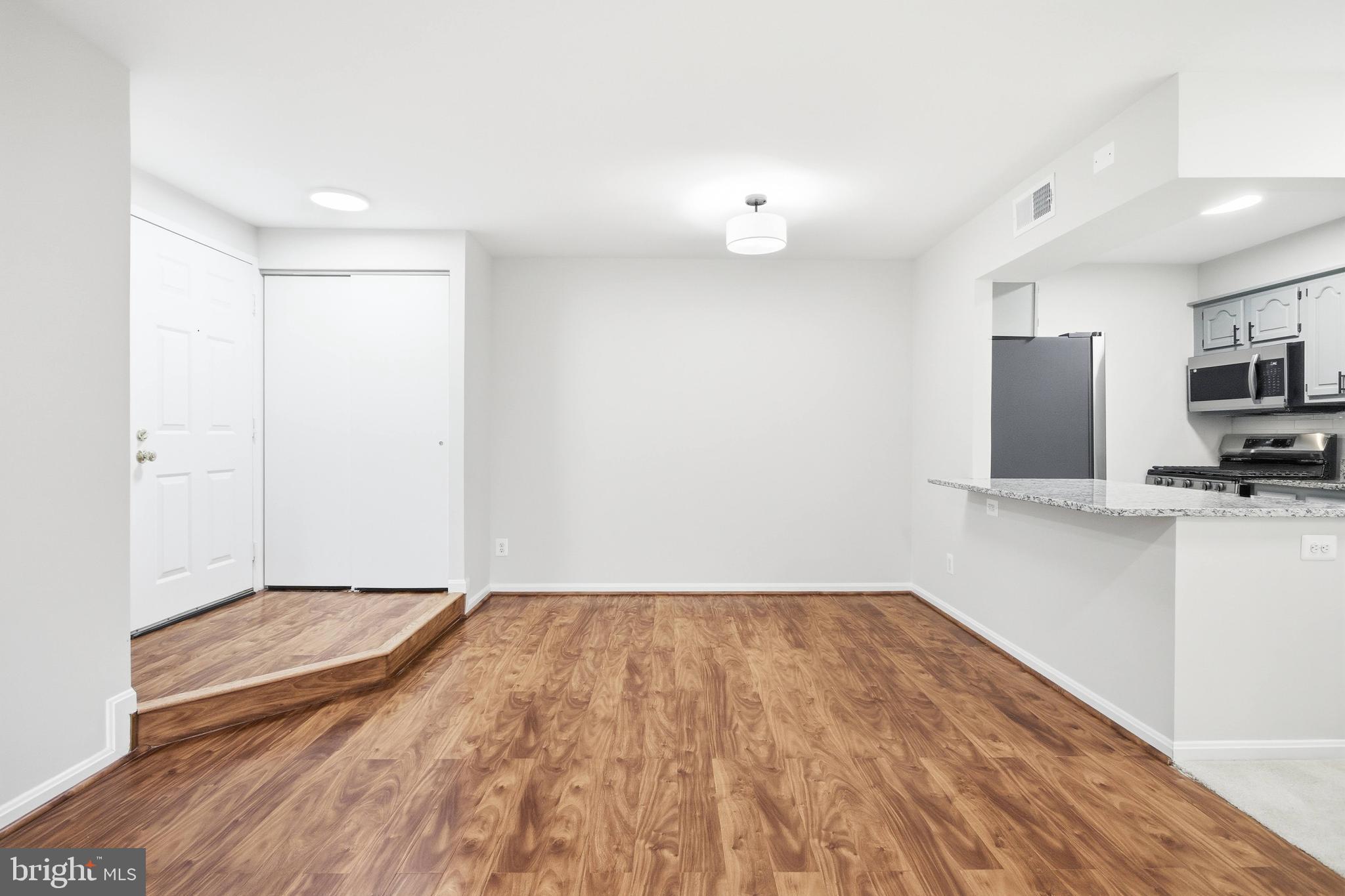 5902 Cove Landing Road, Unit 202 Burke, VA 22015 - Photo 5 of 52 a view of kitchen with wooden floor and electronic appliances