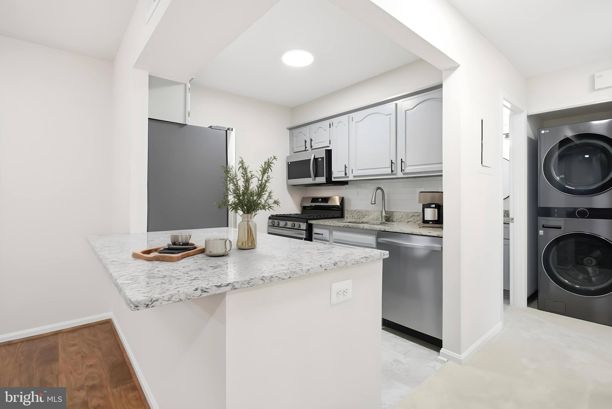 5902 Cove Landing Road, Unit 202 Burke, VA 22015 - Photo 6 of 52 a kitchen with a sink a stove top oven and refrigerator