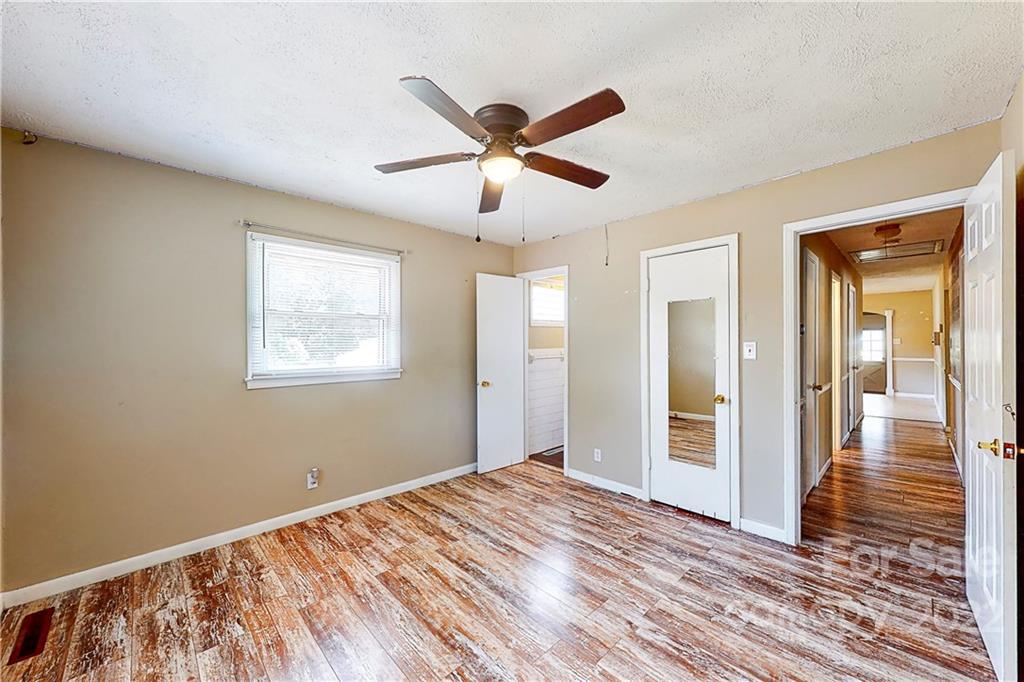 6334 Miller Road Kannapolis, NC 28081 - Photo 26 of 35 a view of a livingroom with a ceiling fan and wooden floor